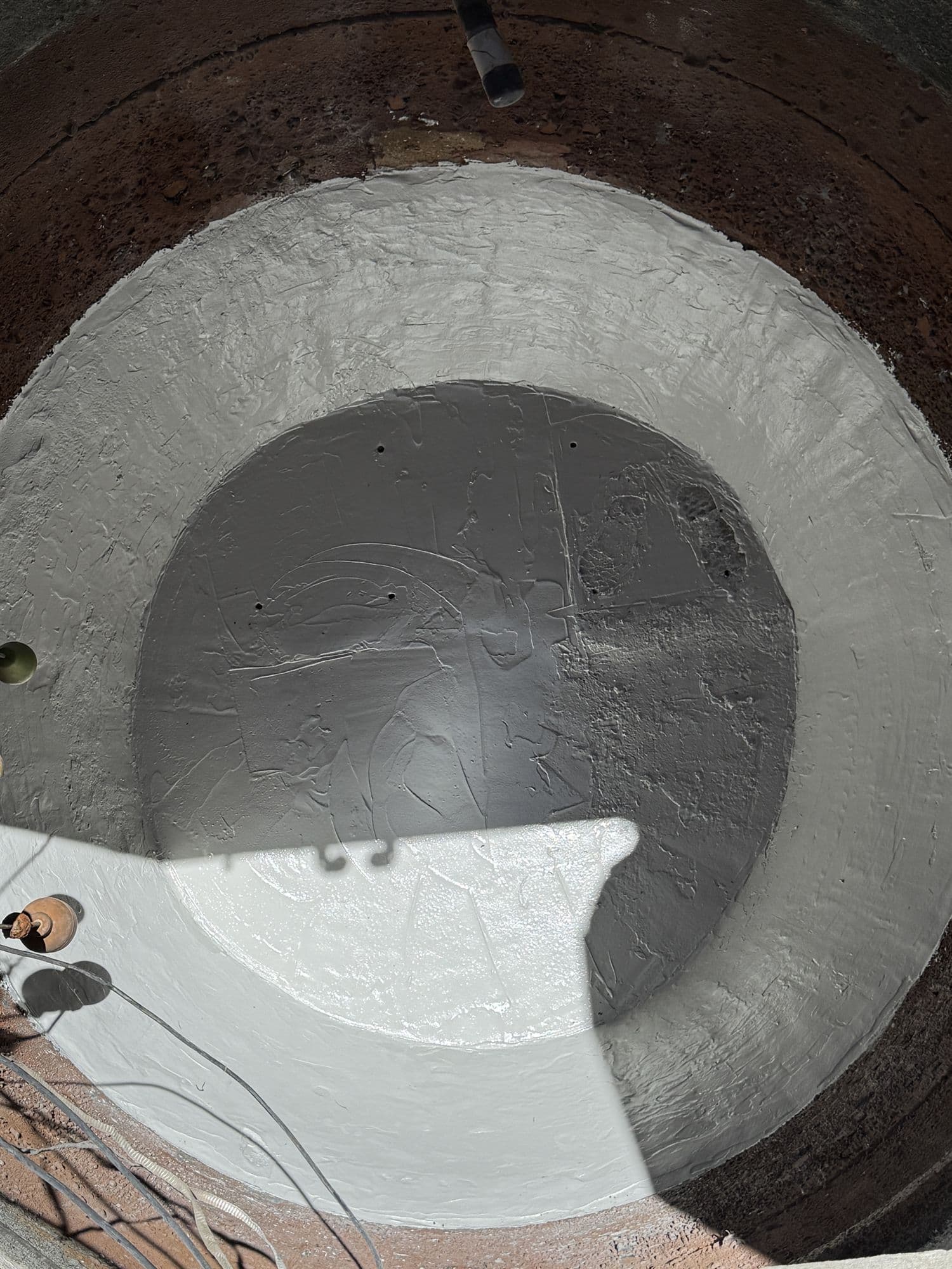 Rehabilitated wastewater structure with protective coating applied